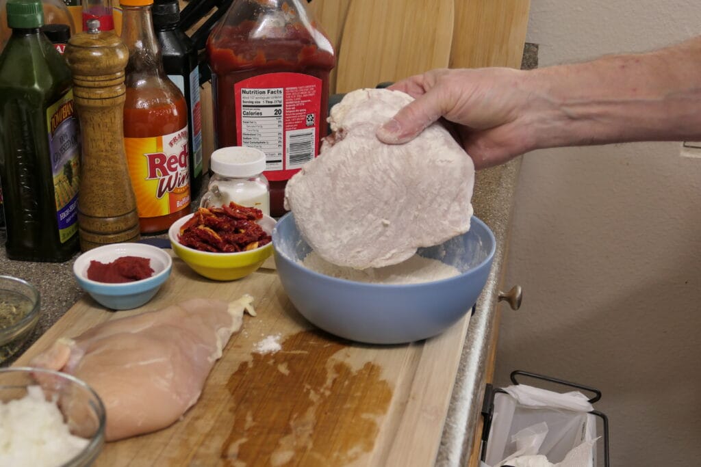 Dredge chicken in seasoned flour